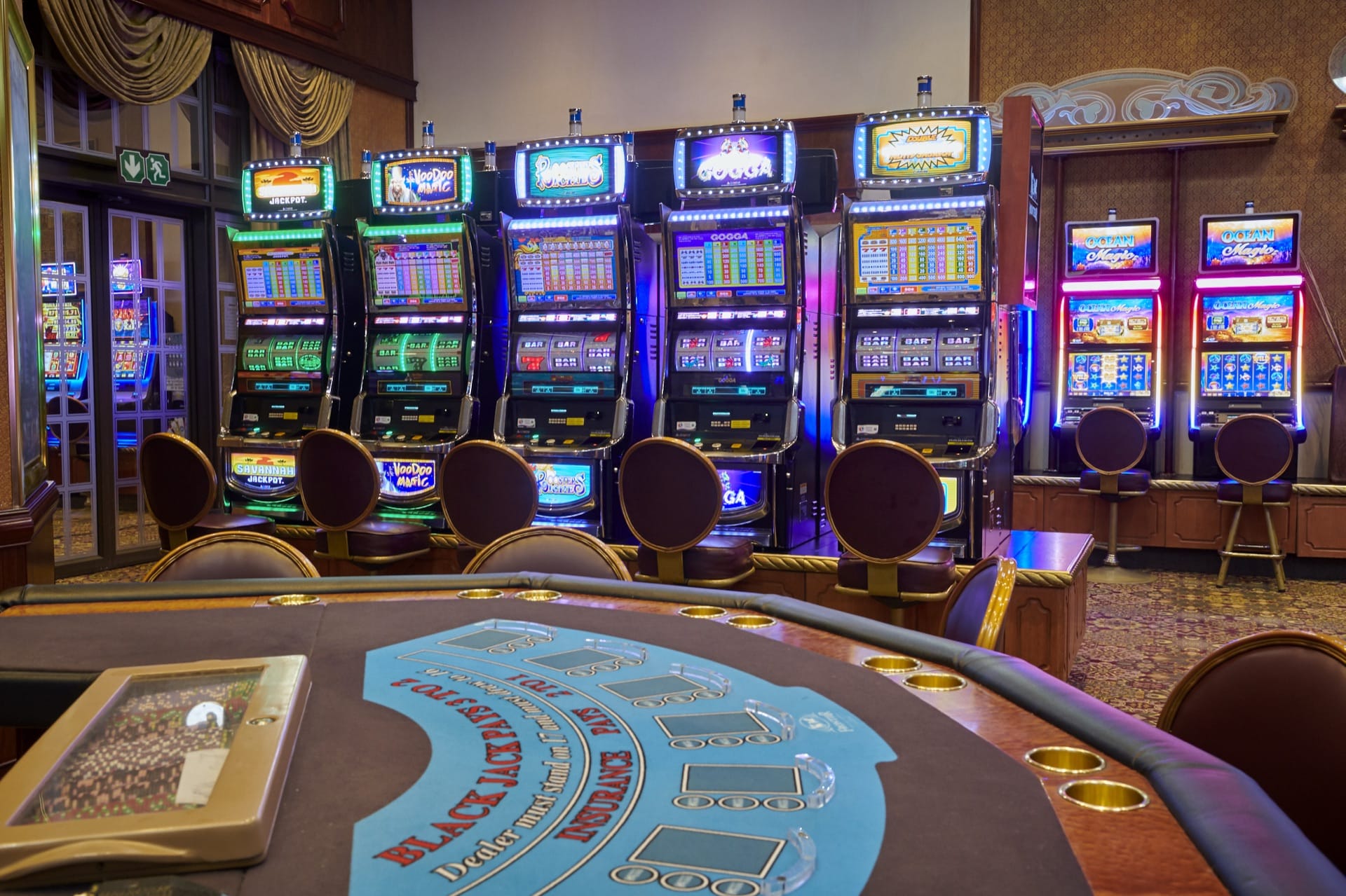 A blackjack table facing slot machines on the casino floor at Frontier Inn, Bethlehem