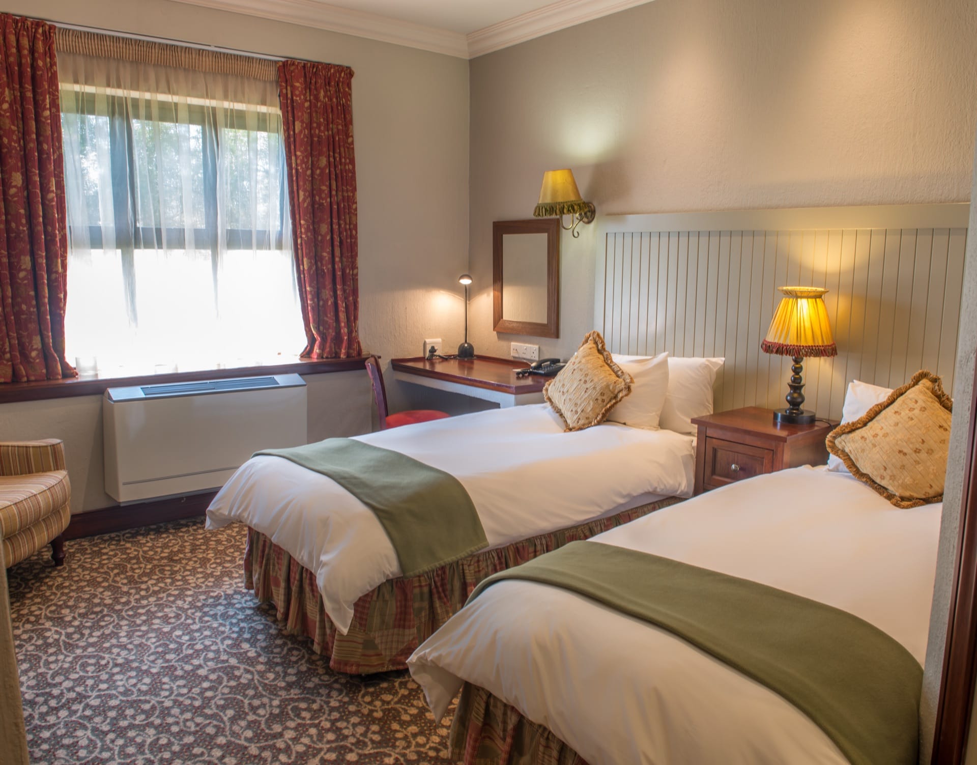 Classic Twin room with two single beds and floral drapes at Frontier Inn, Bethlehem