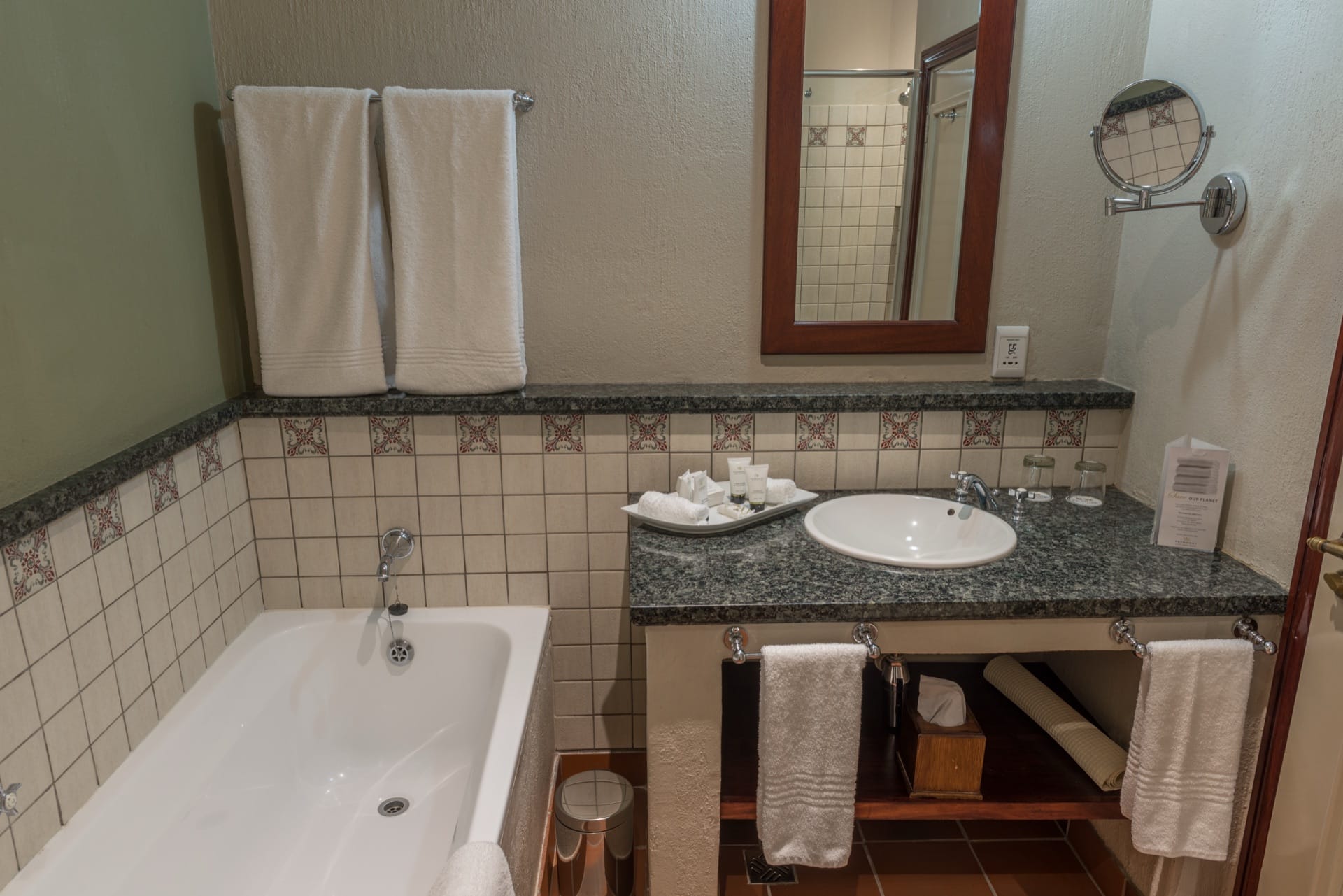 Junior Suite bathroom with bath, granite vanity and toiletries at Frontier Inn, Bethlehem
