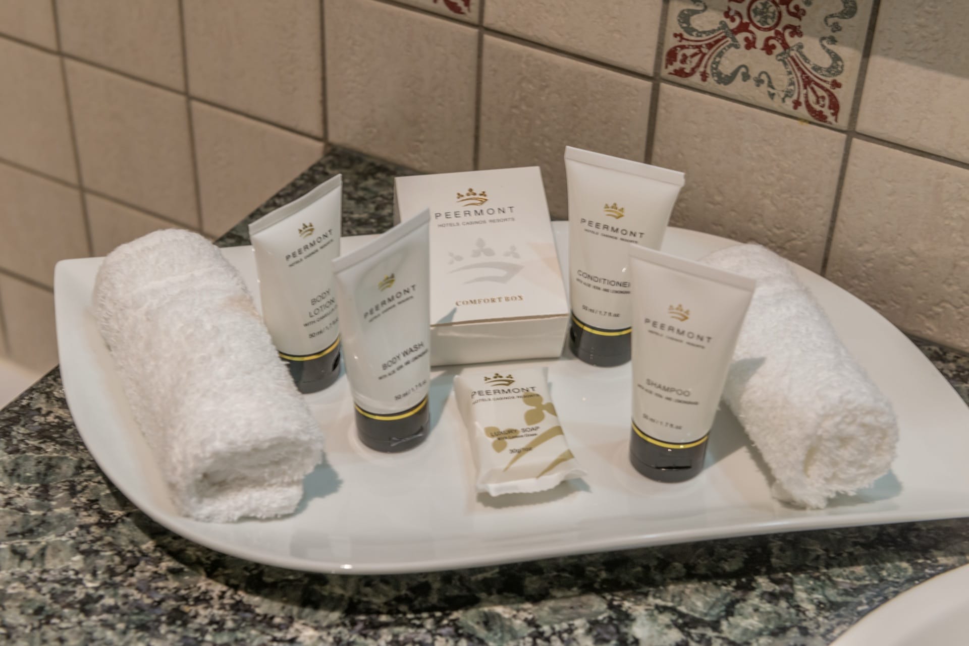 Peermont branded toiletries on the vanity of a Junior Suite at Frontier Inn, Bethlehem