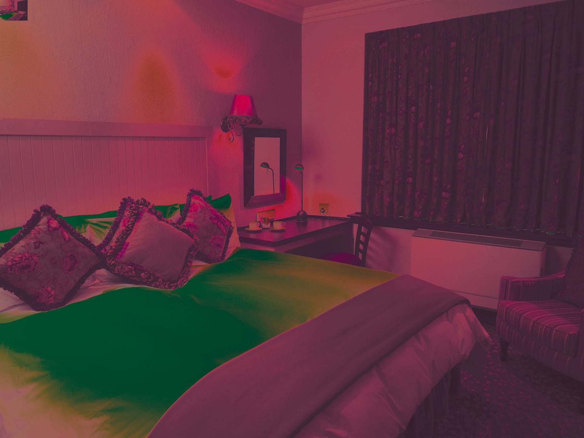 Superior room with double bed and warm lamplight at Frontier Inn, Bethlehem