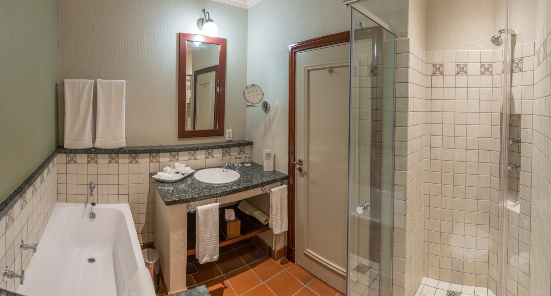 Superior Twin bathroom with bath, separate glass shower and vanity at Frontier Inn, Bethlehem