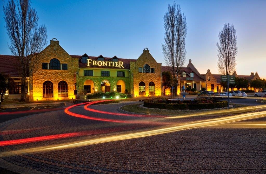 The illuminated stone facade and entrance driveway of Frontier Inn, Bethlehem, at dusk